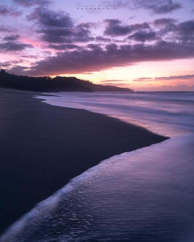 a view of a beach at sunset at Hotel Rural La Sobreisla in Puerto de Vega