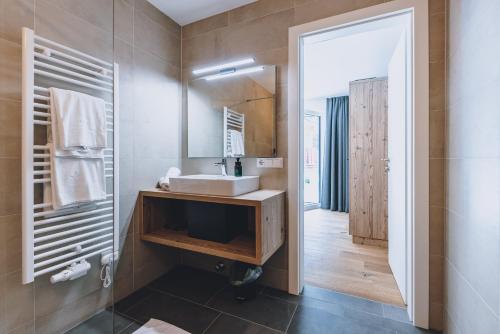 a bathroom with a sink and a mirror at M1 - Mountain Living in Rauris