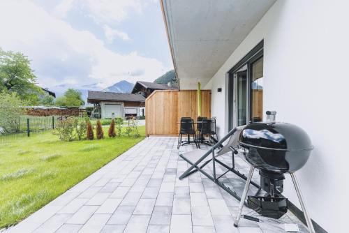a grill on the patio of a house at M1 - Mountain Living in Rauris
