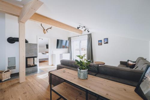a living room with a couch and a table at M1 - Mountain Living in Rauris