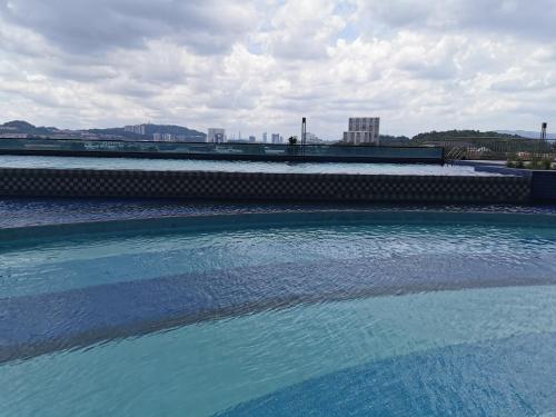 a large pool of blue water with buildings in the background at Apple Home 1 @ Menara Simfoni/Symphony Tower C180/Cheras/Mines/Balakong/Kuala Lumpur in Seri Kembangan