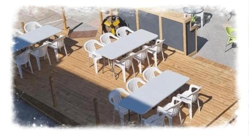 an overhead view of tables and chairs on a deck at Panoramic Holidays - Deluxe 5 in Peyia