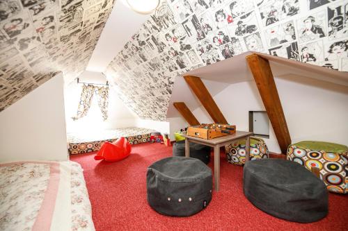 a room with a bed and a table and chairs at Penzion Sonáta in Luhačovice