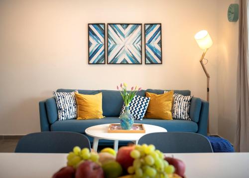 a living room with a blue couch and a table with fruit at NEW! ReLux - ZF Hvar in Hvar