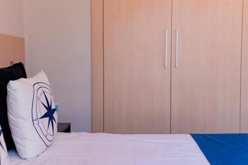 a bedroom with a bed with a pillow and a closet at Hotel Aubí in Sant Antoni de Calonge