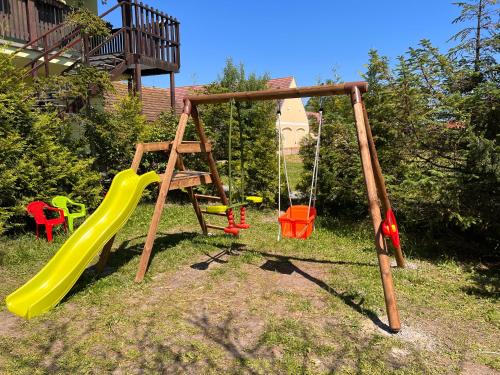 a playground with a slide and swings at Hotel Marislav in Češnovice