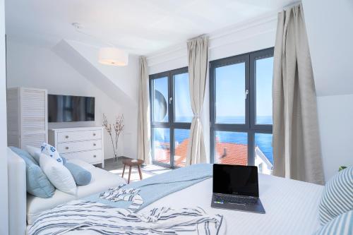 a bedroom with a bed with a laptop on it at NEW! ReLux - ZF Hvar in Hvar