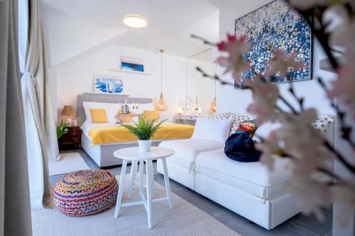 a small bedroom with a bed and a white couch at NEW! ReLux - ZF Hvar in Hvar