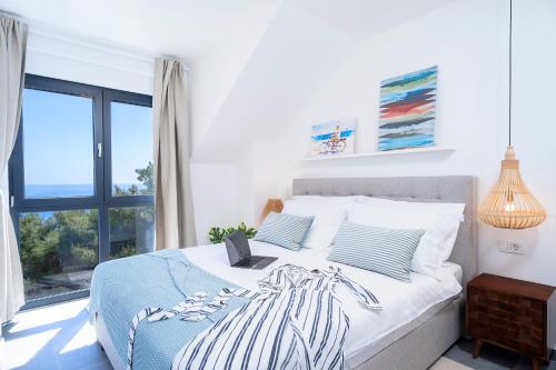 a bedroom with a bed with a laptop on it at NEW! ReLux - ZF Hvar in Hvar