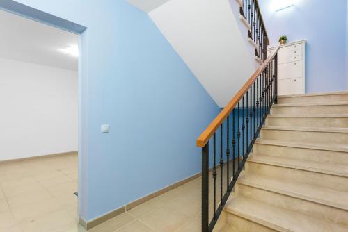 a staircase in a house with blue walls at TORVISCAS SUNSET VILLA 4 rooms & private Jacuzzi in Adeje