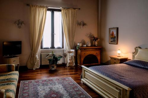 a bedroom with a bed and a large window at PALAZZO Bed and Breakfast in Calvisano