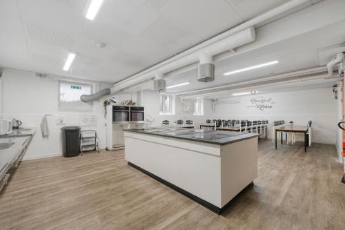 a kitchen with a lot of cabinets and a lot of counter space at Danhostel Odense Kragsbjerggaard in Odense