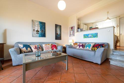 a living room with two couches and a table at Vista sul Mare Loutra Oreas Elenis in Loutra Oraias Elenis 