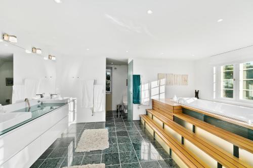 a bathroom with two sinks and a tub and two sinks at DENMARK SEA FRONT ENCHANTING - Beach Villa in Solrød Strand