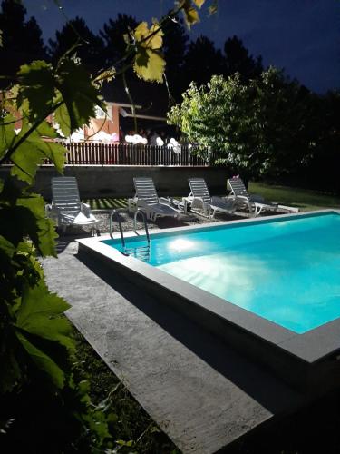 a swimming pool with lounge chairs next to it at Kuca sa bazenom Teja in Arandjelovac
