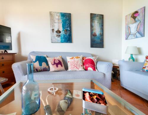 a living room with a couch and a glass table at Vista sul Mare Loutra Oreas Elenis in Loutra Oraias Elenis 
