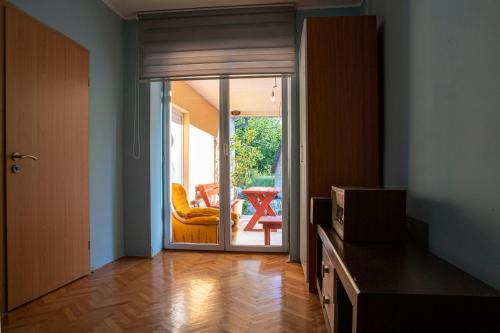 a living room with a door open to a patio at Gazdinstvo Tadić in Nikšić
