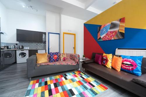 a living room with two couches and a rug at Stylish Stunning City Centre Jesouth Open Plan Boutique Pad in Hull