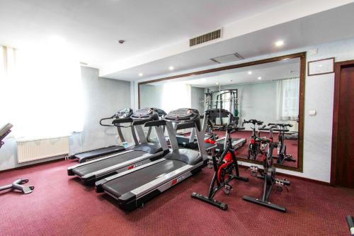 a gym with several tread machines and a mirror at Springs Hotel Ulaanbaatar in Ulaanbaatar