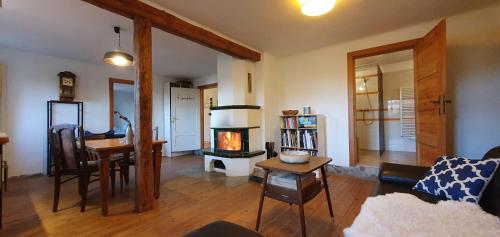 a living room with a fireplace and a table at Apartment Kliemkiker, Nähe Binz in traumhafter Alleinlage in Zirkow