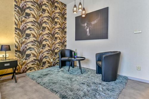 a waiting room with two chairs and a table at Hotel Stračena City in Ostrava