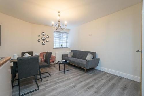 a living room with a couch and a table at The Queens Arms Apartments in Liverpool