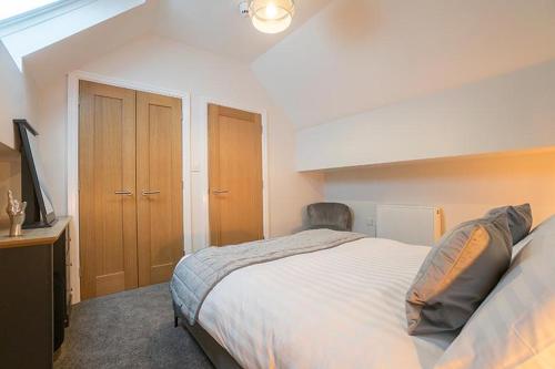a bedroom with a large bed and a television at The Queens Arms Apartments in Liverpool