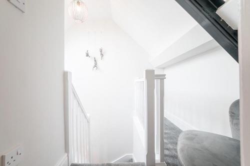 a white room with a staircase with white walls at The Queens Arms Apartments in Liverpool