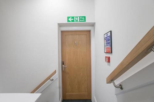a hallway with a door and stairs in a building at The Queens Arms Apartments in Liverpool