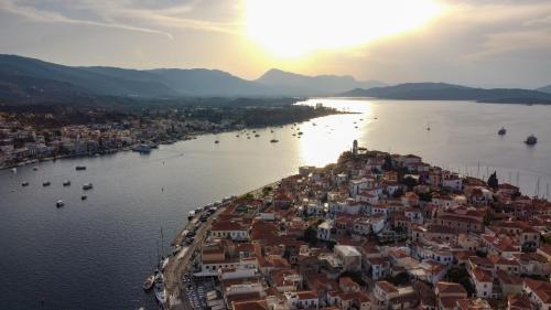 an aerial view of a city with boats in the water at Camara Suite in Poros