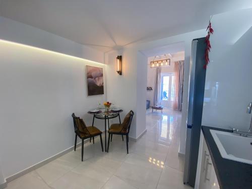 a kitchen and dining room with a table and chairs at Camara Suite in Poros