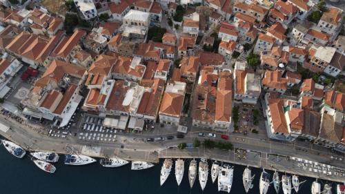 an aerial view of a city with boats in the water at Camara Suite in Poros