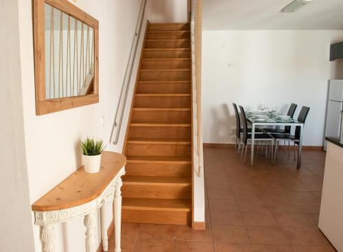 a staircase in a house with a table and a dining room at Casa Ermelinda in Aljezur