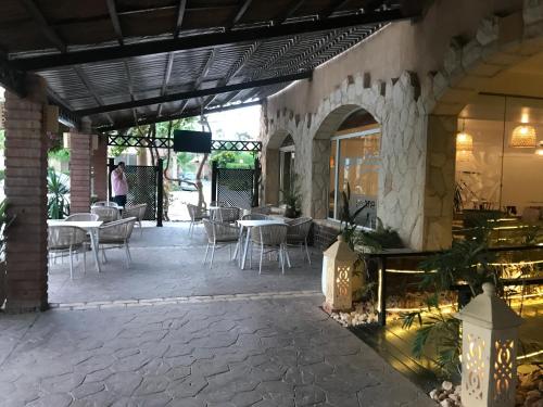 a patio with tables and chairs in a building at Chalet with Roof at Laguna Bay- Ain Sokhna - شالية غرفتين مكيف بالكامل بالرووف قرية لاجونا باي - العين السخنة in Ain Sokhna