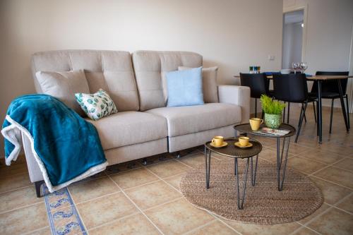 a living room with a couch and two tables at Apartamento Luz de Luna by Family Homes in Denia