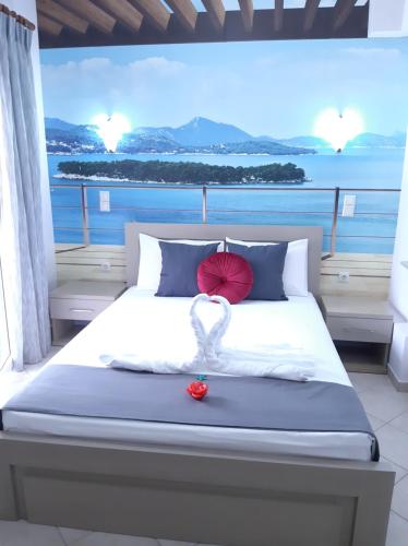 a bedroom with a bed with a view of the ocean at Blue Bay Apartments in Syvota