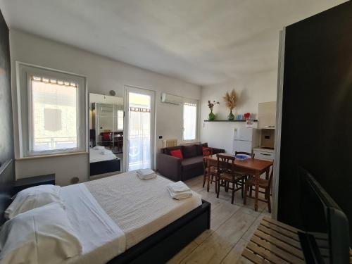 チヴィタノーヴァ・マルケにあるDormi da me sul mareのベッドルーム(大型ベッド1台付)、リビングルームが備わります。