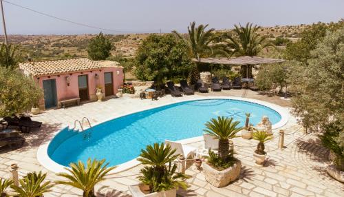 a swimming pool in front of a house at Villa Virginia in Ragusa