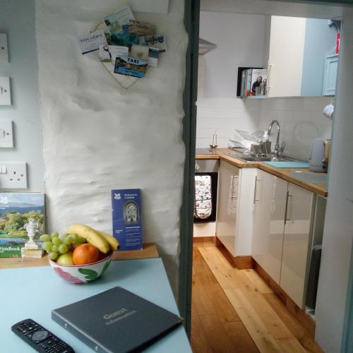 a kitchen with a bowl of fruit on a counter at The Artist's Retreat in Calstock
