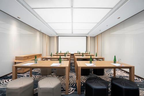 a conference room with tables and chairs and a large window at Melia Koh Samui in Choeng Mon Beach