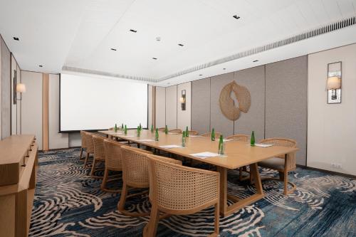 a conference room with a long table and chairs at Melia Koh Samui in Choeng Mon Beach