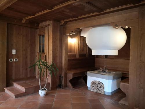 a bathroom with a sink and a potted plant at B&B da mamma Lo in Tolmezzo