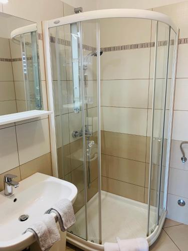 a bathroom with a shower and a sink at FUNTANA-MIA ROOMS B&B in Funtana