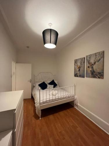 a bedroom with a bed and a lamp in it at Lovely 2 bed flat in SOHO! in London
