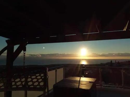a view of the sunset from the balcony of a building at Panoramic Holidays - Deluxe 6 in Peyia
