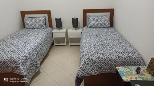 A bed or beds in a room at Al Kawtar