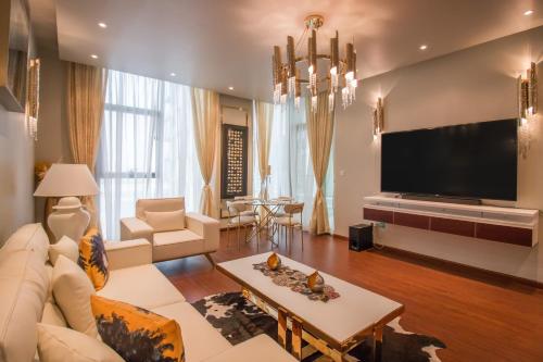 a living room with a couch and a tv at Luxurious 2BR - Fully Upgraded - High-end facilities in Dubai