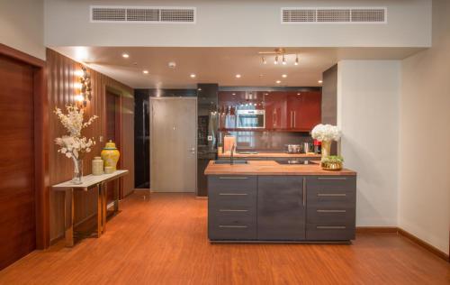 a kitchen with wooden floors and stainless steel appliances at Luxurious 2BR - Fully Upgraded - High-end facilities in Dubai