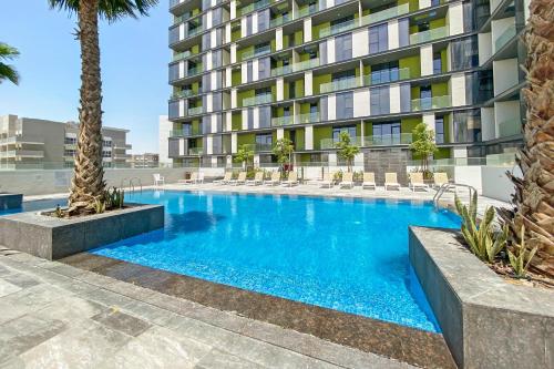 a swimming pool in front of a building at Luxurious 2BR - Fully Upgraded - High-end facilities in Dubai