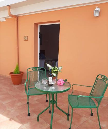a table with two chairs and a bottle of wine at Hotel Alvaro frente Palacio-Museo Selgas in Cudillero